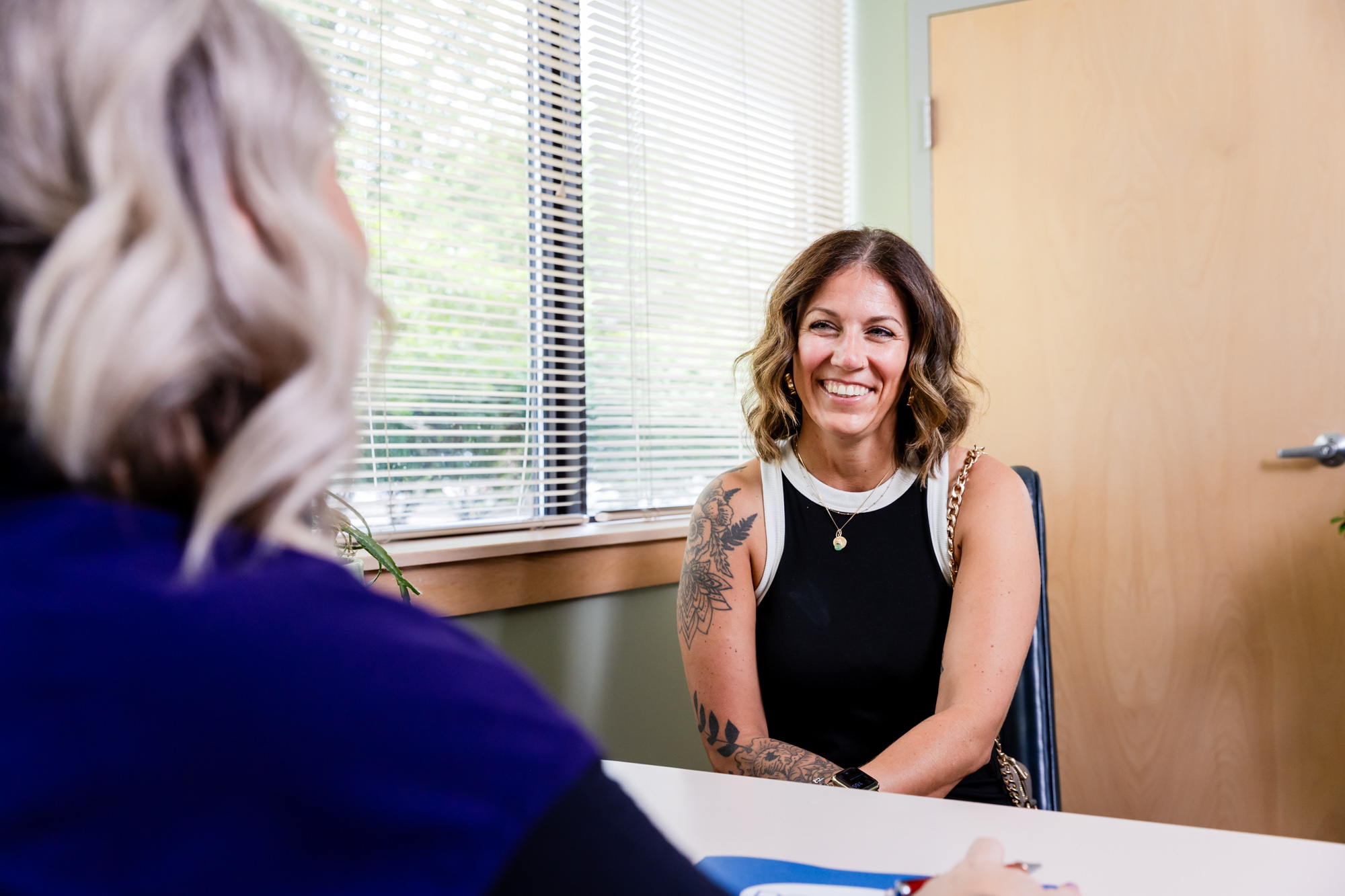 A smiling woman meets with a provider for a vein screening in Columbus, OH