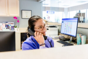 A provider talks on the phone to schedule a vein screening in Columbus.